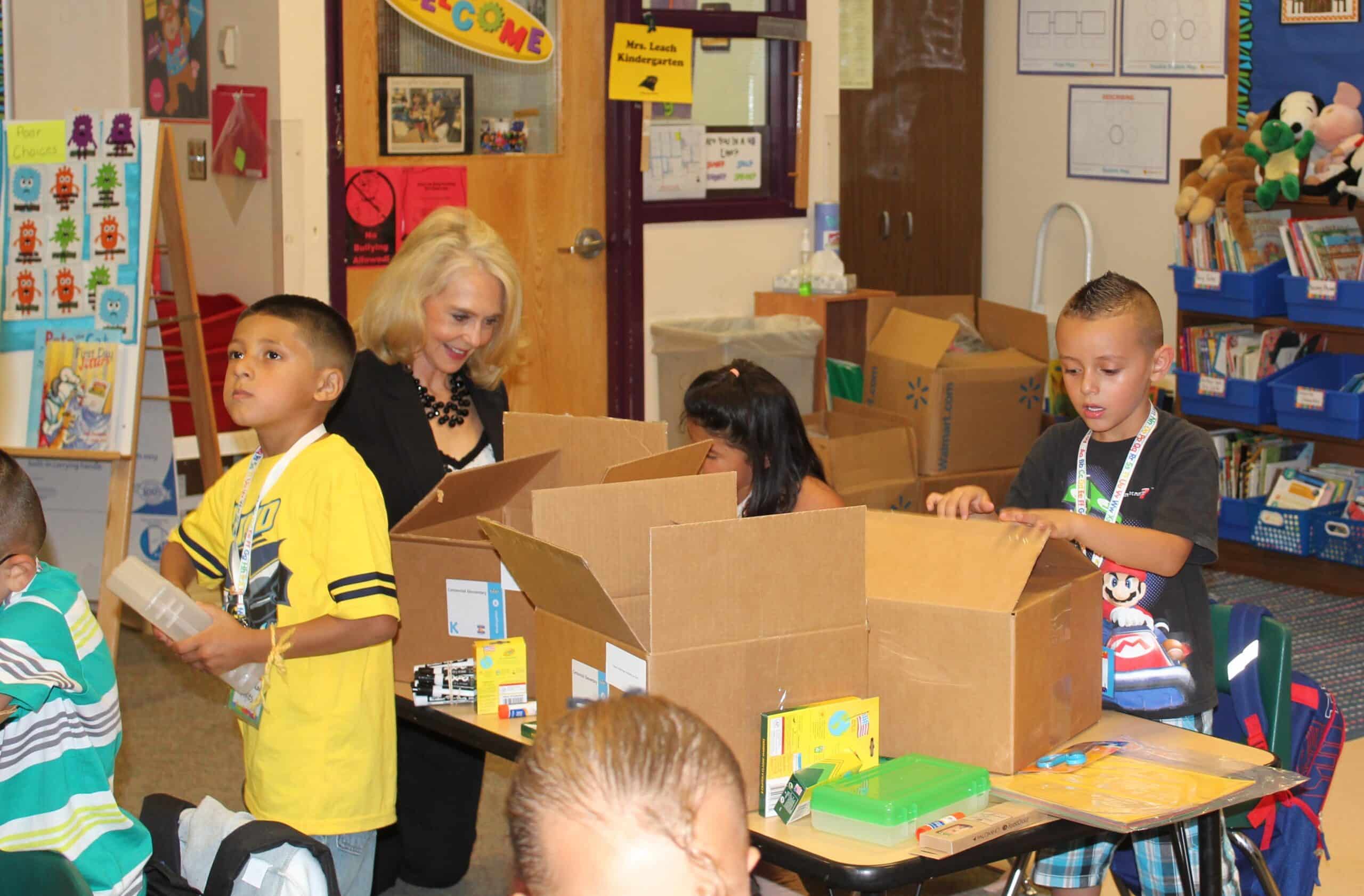 Karen McDivitt helps unpack donated school supplies