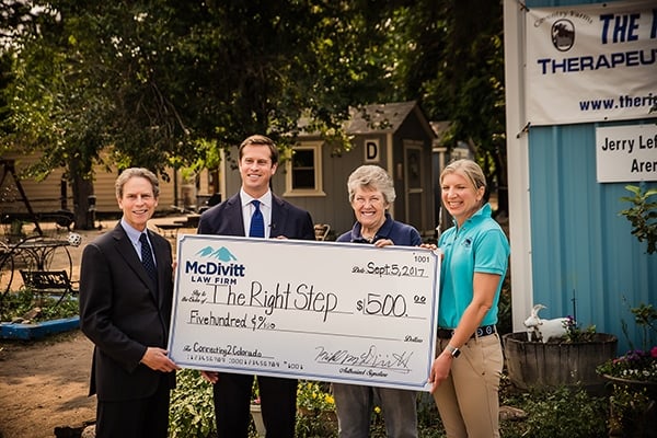 McDivitt Law Firm Team and The Right Step with Large Check