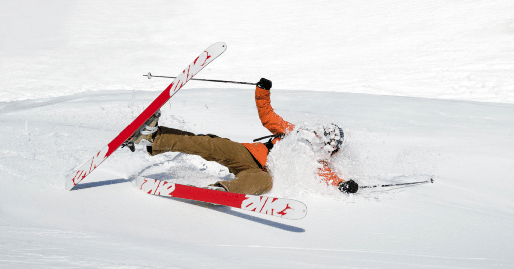 a fallen skier covered in snow