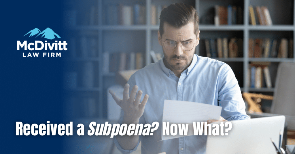 Man confused reading paper document with caption "received a subpoena? Now what?"