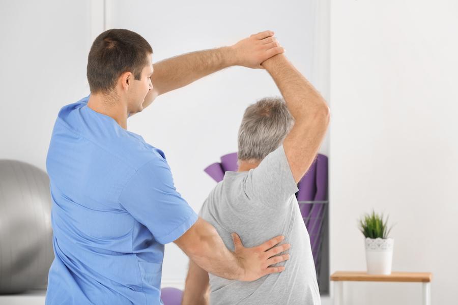 Workers Compensation Rehabilitation - Nurse Stretching Elder