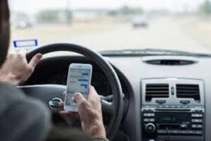 man texting while driving